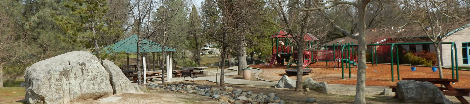 An image depicting the play structures, gazebo, and picnic benches at Pioneer Park